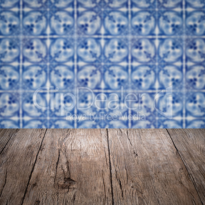 Wood table top and blur vintage ceramic tile pattern wall