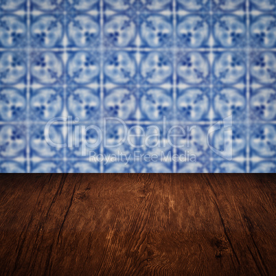 Wood table top and blur vintage ceramic tile pattern wall