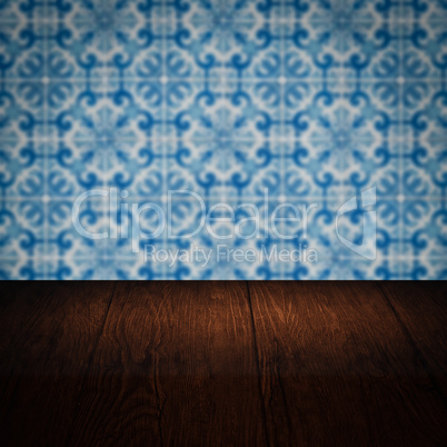 Wood table top and blur vintage ceramic tile pattern wall