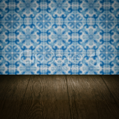 Wood table top and blur vintage ceramic tile pattern wall