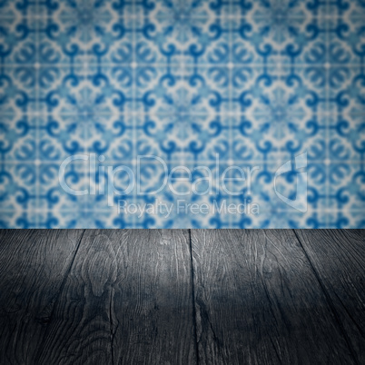Wood table top and blur vintage ceramic tile pattern wall Wood table top and blur vintage ceramic tile pattern wall