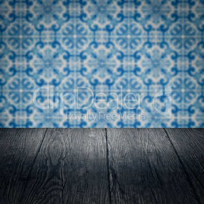 Wood table top and blur vintage ceramic tile pattern wall