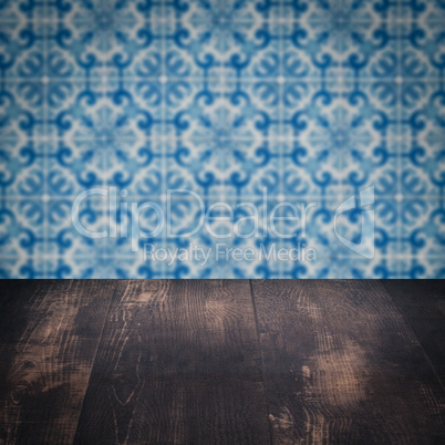 Wood table top and blur vintage ceramic tile pattern wall