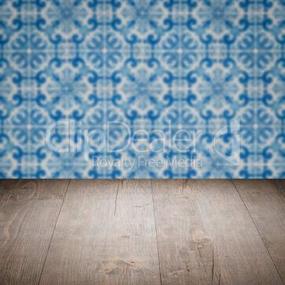 Wood table top and blur vintage ceramic tile pattern wall