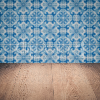 Wood table top and blur vintage ceramic tile pattern wall Wood table top and blur vintage ceramic tile pattern wall