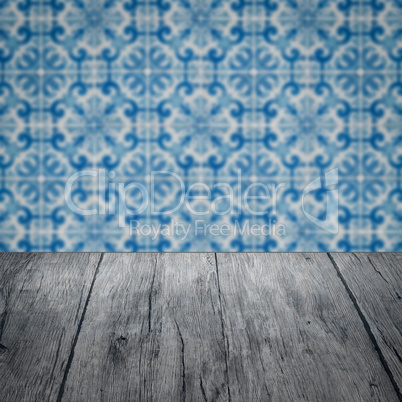 Wood table top and blur vintage ceramic tile pattern wall