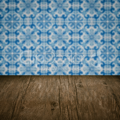 Wood table top and blur vintage ceramic tile pattern wall