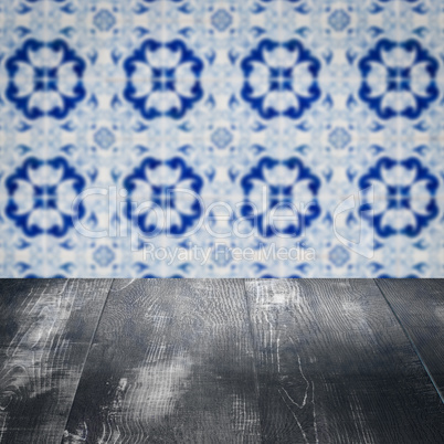 Wood table top and blur vintage ceramic tile pattern wall