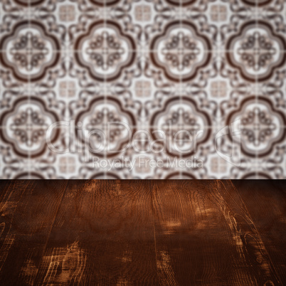 Wood table top and blur vintage ceramic tile pattern wall