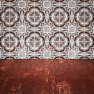 Wood table top and blur vintage ceramic tile pattern wall