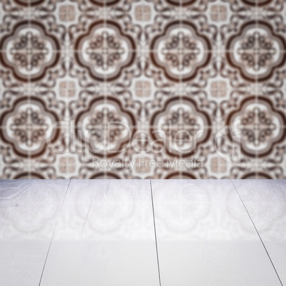 Wood table top and blur vintage ceramic tile pattern wall