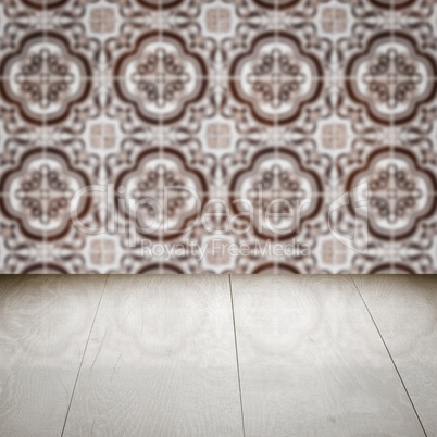 Wood table top and blur vintage ceramic tile pattern wall