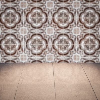 Wood table top and blur vintage ceramic tile pattern wall