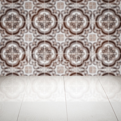 Wood table top and blur vintage ceramic tile pattern wall