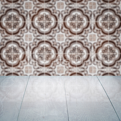 Wood table top and blur vintage ceramic tile pattern wall