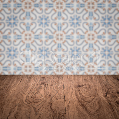 Wood table top and blur vintage ceramic tile pattern wall