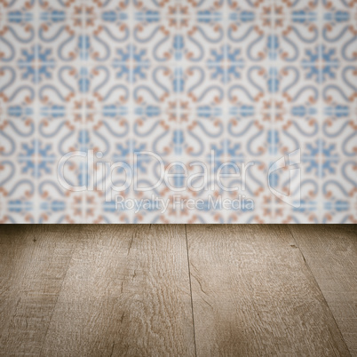 Wood table top and blur vintage ceramic tile pattern wall