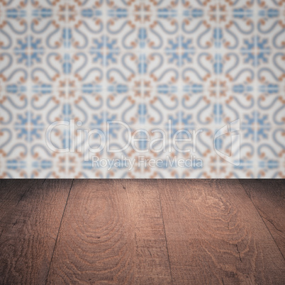Wood table top and blur vintage ceramic tile pattern wall Wood table top and blur vintage ceramic tile pattern wall