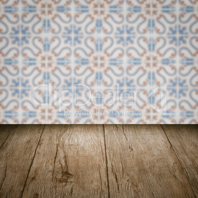 Wood table top and blur vintage ceramic tile pattern wall