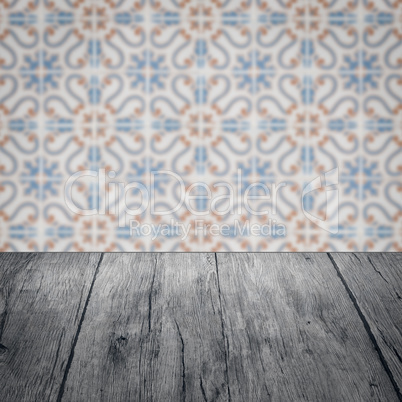 Wood table top and blur vintage ceramic tile pattern wall