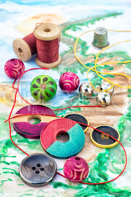 Threads and embellishments on a colorful background