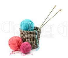 Multicolored balls and needles in basket