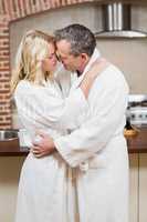 Cute couple about to kiss in bathrobes