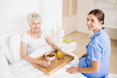 Nurse taking care of suffering senior patient