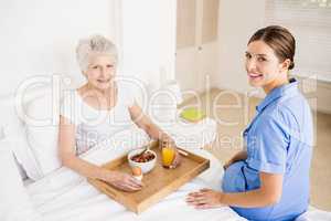 Nurse taking care of suffering senior patient
