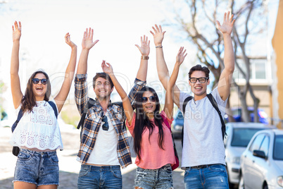 Hip friends triumphing with raised arms