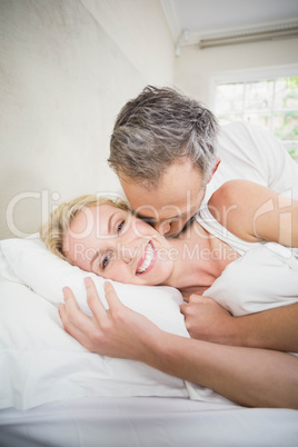 Cute couple cuddling in bed