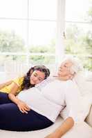 Relaxed granddaughter and grandmother napping