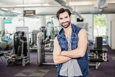 Handsome man standing with arms crossed