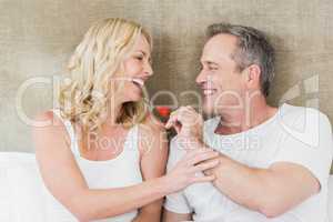 Husband giving a strawberry to wife