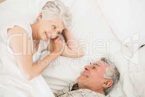 Happy senior couple on bed