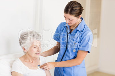 Doctor taking care of suffering senior patient