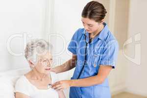 Doctor taking care of suffering senior patient