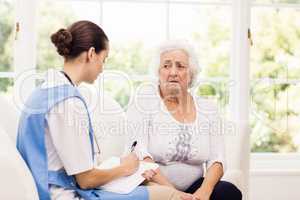 Nurse taking care of sick elderly woman