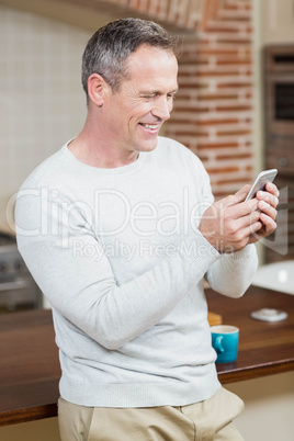 Handsome man looking at smartphone