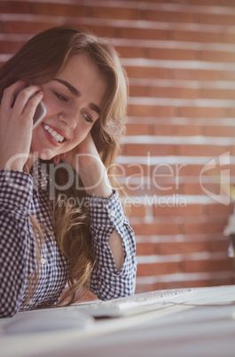 Young hipster businesswoman calling with her phone