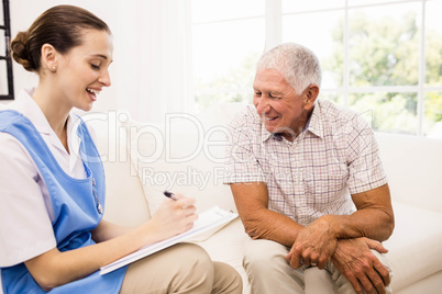 Nurse taking care of sick elderly patient