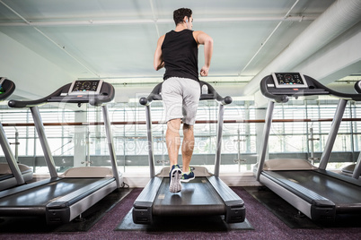 Fit man running on treadmill