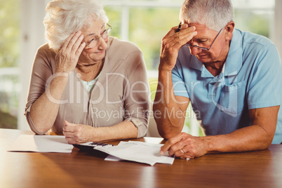 Senior couple counting bills