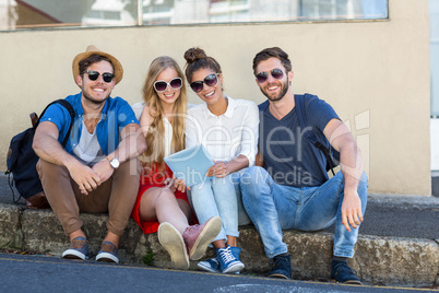 Hip friends holding tablet and laughing