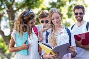 Hip friends reading notes on notebooks