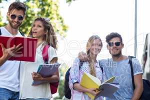 Hip friends reading notes on notebooks