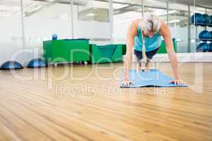 Fit blonde planking on mat