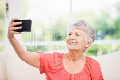 Happy senior woman taking selfie