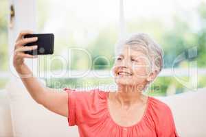 Happy senior woman taking selfie