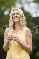 Happy woman drinking glass of champagne